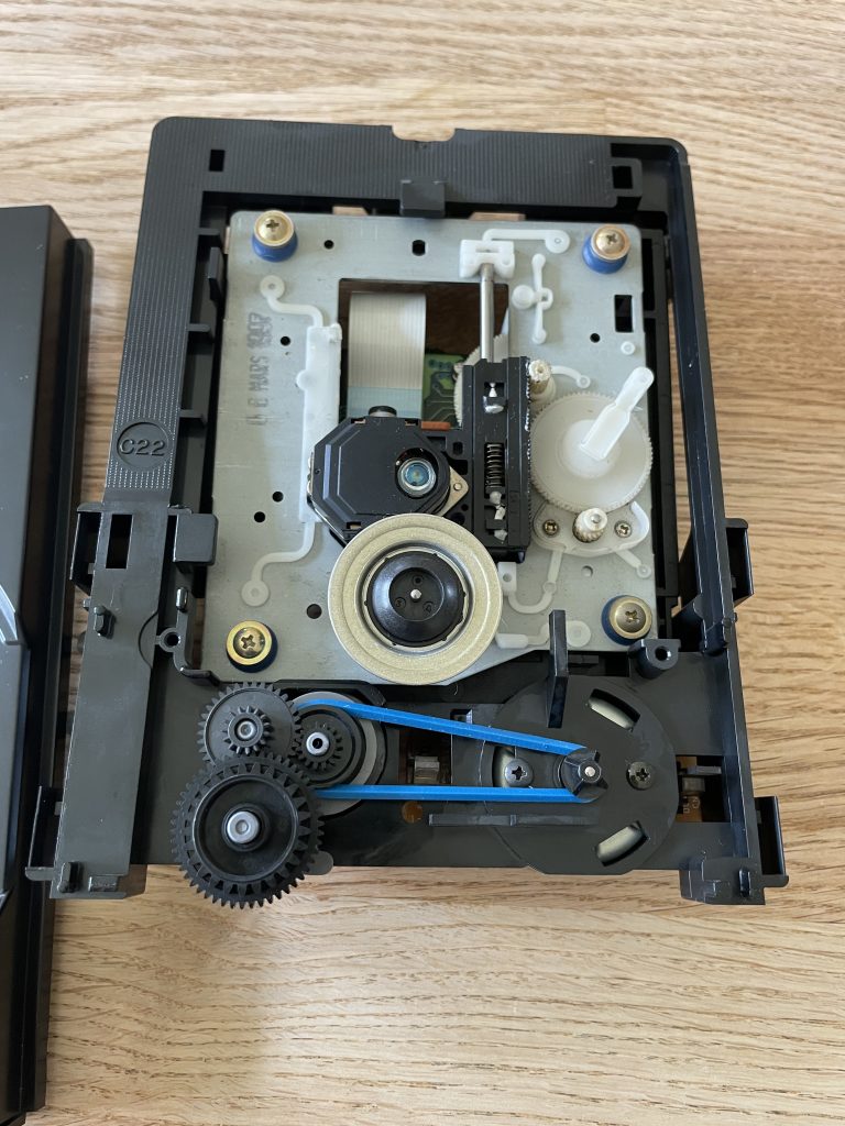 Sony Compact Disc Player CDP-EX200 CD tray assembly removed from chassis. A new blue silicone belt is seen on the belt wheels.